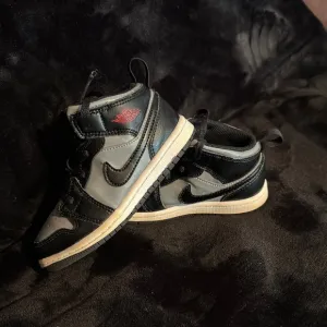 Black and Gray High-Top Sneakers with Red Accent