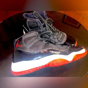 Jordan 11 Black and Red Sneakers with Patent Leather