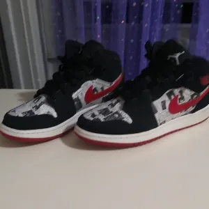 Jordan 1s Newspaper Black and Red High-Top Sneakers