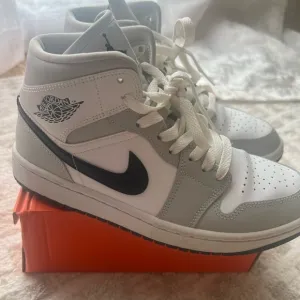 Jordan White and Gray Athletic Shoes with Iconic Design