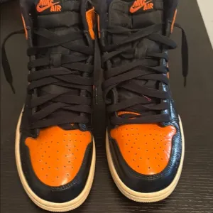 Nike Air Black and Orange High-Top Sneakers